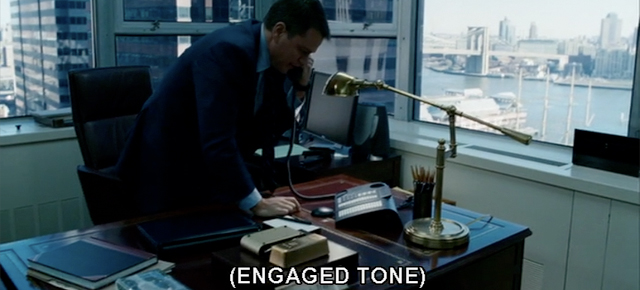 A screenshot from The Adjustment Bureau featuring Matt Damon on the phone with a caption displaying 