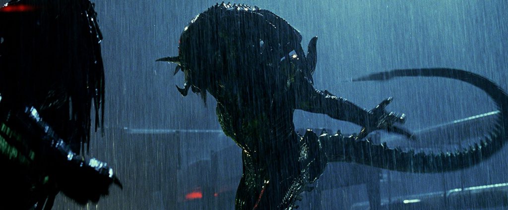 Alien fighting Predator in the rain at night in this frame from Aliens vs Predator: Requiem
