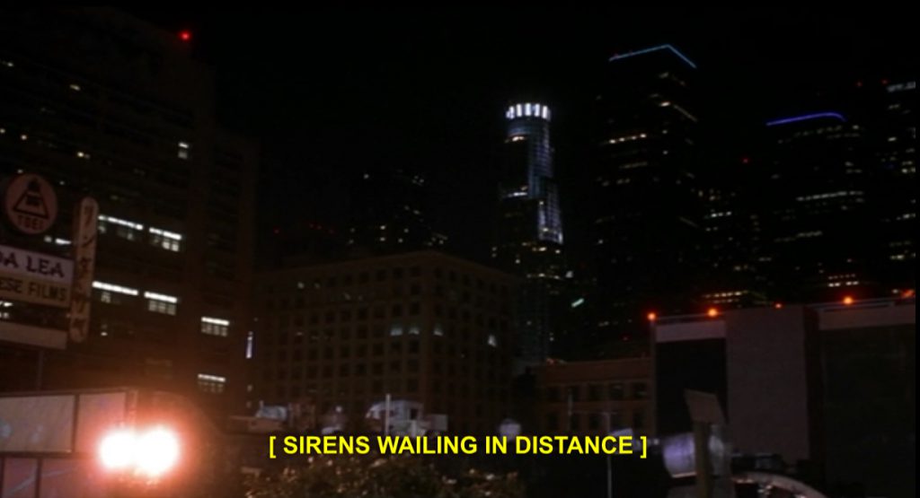 A frame from Prophecy 3: The Ascent featuring a cityscape at night and the closed caption: [SIRENS WAILING IN DISTANCE]