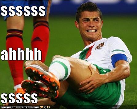 Soccer player sits on the grass, leaning back grabbing his thigh with a slight pained look on his face. The text on image: ssssss ahhhh sssss.