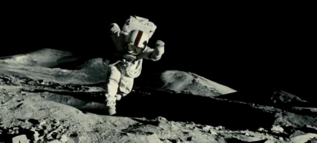 A frame from Apollo 18 showing Nate being pulled into a moon crater.