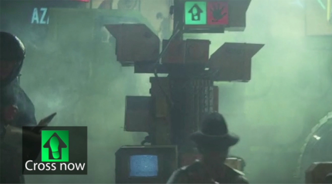 A frame from Blade Runner (1982) featuring a custom cross walk icon as an experiment caption.